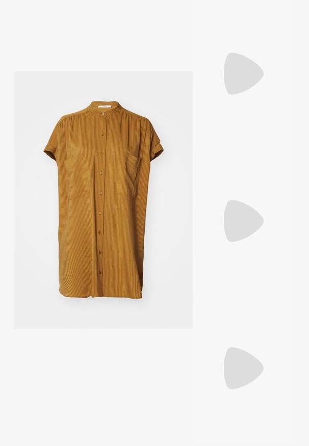 Camisa curta, amarela mostarda, com colarinho mandarim, mangas curtas enroladas e textura canelada vertical. Dois bolsos frontais.; Sandálias de couro vegan douradas com duas correias ajustáveis, palmilha de cortiça e sola de borracha escura. Textura suave com acabamento metálico.; Óculos de sol retangulares com armação de plástico em padrão tartaruga, lentes escuras e detalhes em prata nas laterais. Fabricado na Itália.; Bolsa crossbody de pele castanha com padrão de logo, alça de corrente dourada, fecho com zíper e detalhes em metal dourado. Forma compacta e retangular.