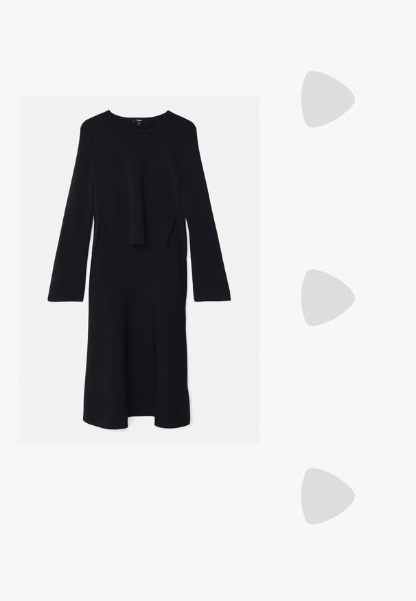 Robe noire à manches longues en tissu doux. Présente une coupe décontractée avec un haut superposé et un ourlet évasé. Encolure ronde simple sans embellissements.; Baskets en cuir blanc, design bas, avec une texture lisse, bout rond, lacets à l'avant et un petit logo brodé sur le côté.; Sac demi-lune en cuir noir avec des accents en métal doré, doté d'une fermeture éclair. Porté en bandoulière sur un pull gris.; Boucles d'oreilles avec clou en métal doré et design torsadé. Chaque boucle d'oreille est dotée d'un arrière transparent circulaire pour un port sécurisé.