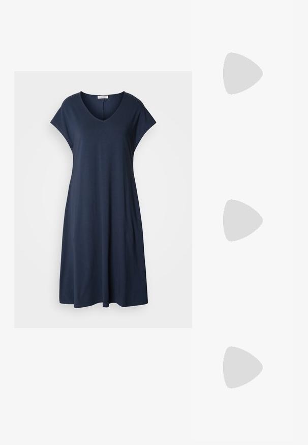 Navy blue, short-sleeve dress with a V-neck and relaxed fit. Made from soft material, it features a flowing silhouette and minimal accents.; Black patent leather slingback heels with a pointed toe, a rounded cutout design, and a block heel. Features a gold-tone buckle accent.; Black oversized sunglasses with gradient lenses, thick frames, and gold-tone chain detailing on the temple arms.; Black handbag with structured shape, smooth texture, and a metallic clasp. Paired with wide black pants and open-toe sandals on wooden floor.