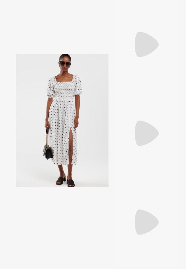 Weißes Kleid mit weißen Punkten, samt Puffärmeln, gerafftem Oberteil und seitlichem Schlitz. Kombiniert mit schwarzen Block-Absatzsandalen und einer schwarzen Handtasche.; Braune Wildleder-Westen-Stiefelette mit spitzem Zeh, besticktem Design und einem niedrigen, gestapelten schwarzen Absatz. Mit Zuglaschen für einfaches Anziehen.; Schwarze übergroße Sonnenbrille mit braunen Gläsern. Merkmale sind einzigartige gestreifte Bügel in Grün und Rot sowie goldene Hardware-Akzente. Quadratische Form.; Rote Leder-Clutch mit einem goldfarbenen Rahmenverschluss und einem kleinen "Wittchen"-Markenlabel in der Mitte der Vorderseite.