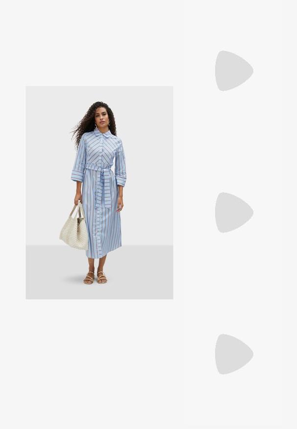 Light blue, striped mid-length shirt dress with a tied waist, button-down front, and three-quarter sleeves. Paired with a woven bag.; White slingback heel with a pointed toe, smooth upper material, low block heel, and side cut-out design with adjustable buckle strap.; Round sunglasses with dark lenses and gold frames. The model wears a light blue, ribbed cardigan with buttons and contrast white sleeves.; Michael Kors wristlet in beige coated canvas featuring a repeating MK logo pattern, gold hardware, and a detachable chain strap.