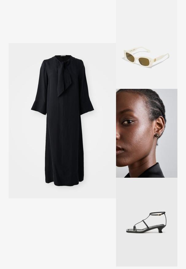 Fekete midi ruha álló gallérral és masnival, hosszú ujjakkal és laza szabással, sima anyagból készült, matt felülettel.; Fekete bőr szandál, négyzet alakú orral, vékony pántokkal, állítható bokapánttal és alacsony sarokkal. A pánton egy kis arany dísz található.; Fehér műanyag napszemüveg téglalap alakú kerettel, barna lencsékkel és arany díszítéssel a szárán. Simább textúra és modern dizájn.; A fém virágmintás fülbevalónak texturált fekete közepe és finom részletei vannak. A modellen tiszta bőre és fonott haja oldalnézetből látható.