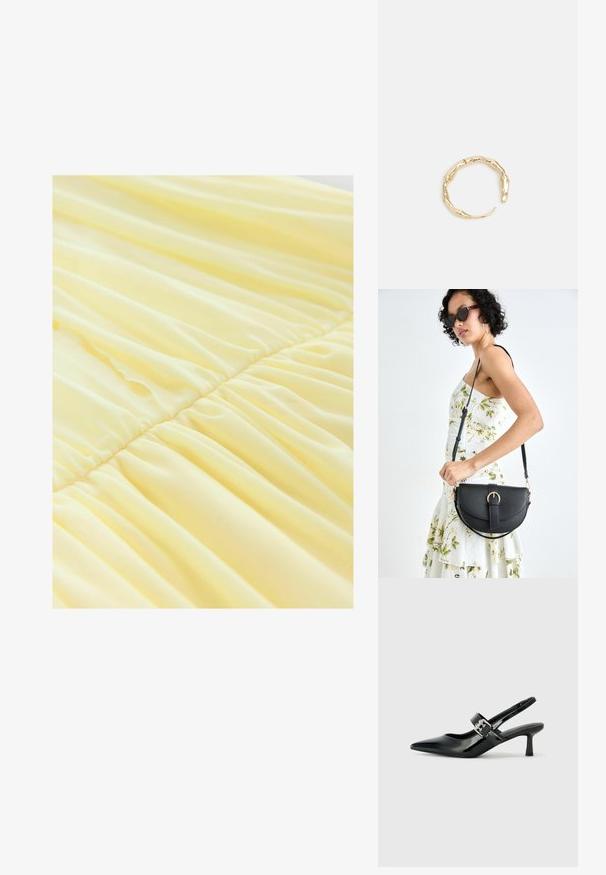 Geltona suknelė, pagaminta iš minkštos, lengvos medžiagos, su susiraukšlėjusiomis dalimis ties liemeniu, sukuriančiomis plytėjantį tekstūrą ir švelnų kritimą.; Juodai lakuoti slingback aukštakulniai su smailiu kojų pirštu ir mažais blokiniais kulniukais, su sidabro sagtimi ant dirželio.; Juodas odinis krepšys su išlenkta forma, nuimamu dirželiu ir auksiniais detalėmis. Krepšys turi kilpą su sagtimi.; Auksinės spalvos žiedas, turintis organišką, sukimosi dizainą su lygiu paviršiumi ir siaurėjančiais galais, sukuriantis modernią skulptūrinę išvaizdą.
