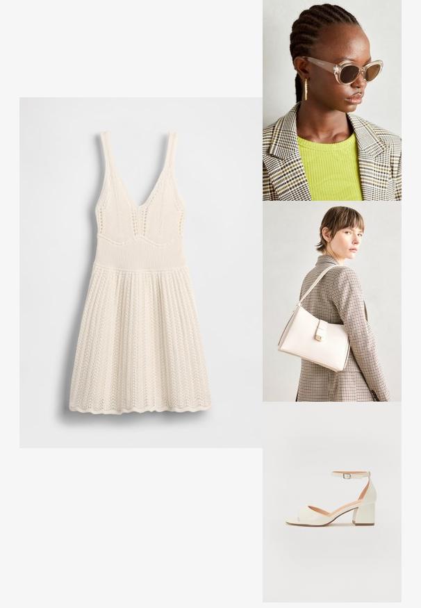 Vestido de malha em creme, com decote em V, corpete canelado e saia evasê com bainha ondulada e padrão de rendilhado por todo o vestido.; Sandal de salto creme com tira no tornozelo, bico aberto e salto bloco. Textura de couro suave com um design minimalista.; Óculos de sol estilo cat-eye claros com lentes castanhas e armação transparente. Modelo a usar uma blusa verde com nervuras e um blazer de tecido xadrez. Brincos em forma de argola dourados.; Bolsa de mão em couro branco com um design estruturado, apresentando um fecho magnético e uma alça de ombro, exibida sobre um fundo neutro.