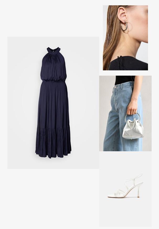 Mørkeblå halterneck kjole lavet af blød, flydende stof med en samlet bodice, elastisk talje og en lagdelt flæsekant.; Hvide strop sandaler med høj hæl, flad tåbase, tekstureret forside med sammensunkne detaljer og en smal ankelrem.; Metallic sølv bucket bag med en tekstureret overflade, prydet med et sølv rundt håndtag og snørelukning, holdt mod lyseblå jeans.; Sølv hoop ørestik med en poleret overflade, prydet med små guld accenter og en rund form, båret på øreflippen.