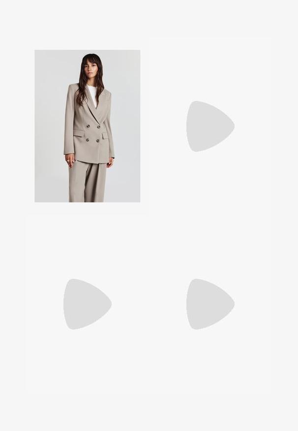 Young woman with long brown hair wears beige double-breasted blazer and matching wide-leg pants, standing against plain light background.; White short-sleeve t-shirt made from smooth fabric, featuring a round neckline and subtle stitching details at the hem.; Light blue wide-leg jeans made of denim, featuring a high waist, front pockets, and a button closure. Smooth texture with faded areas.; Brown leather loafers with a chunky outsole, featuring gold hardware accents and stitched detailing on the upper for added texture.