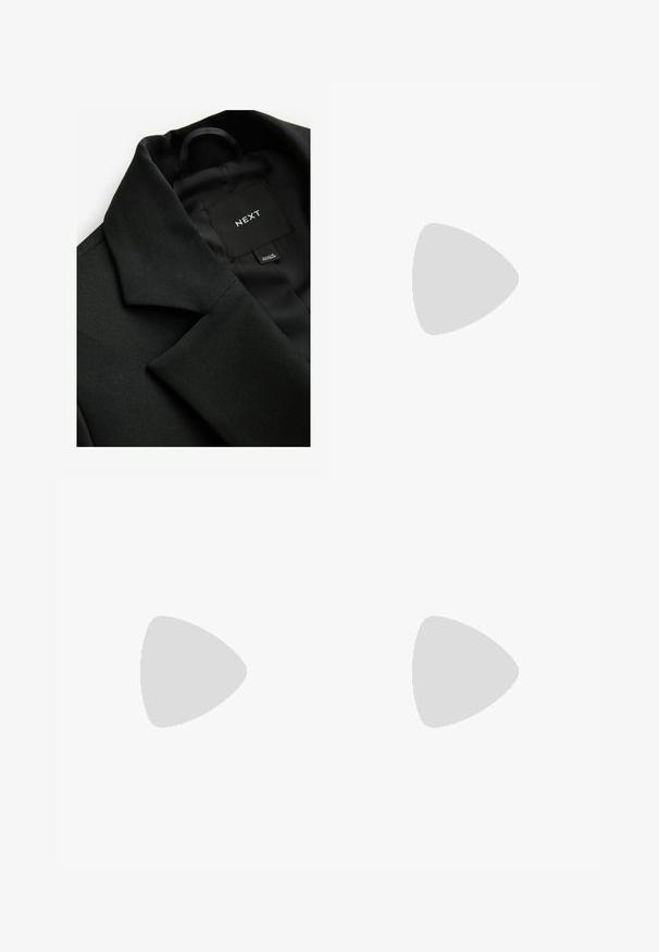 Black blazer with textured fabric, a notched collar, and a smooth inner lining. Tag with "NEXT" visible inside the collar.; Black long-sleeve top with a cowl neck, made from a soft, smooth fabric; fitted design with straight hem and no visible seams.; Black leggings with an elastic waistband, made of a smooth, stretchy fabric. Features a fitted design tapering at the ankles.; Sport shoes with a white leather upper, gray suede toe, and three black stripes. Features a blue logo on the tongue and a textured rubber sole.