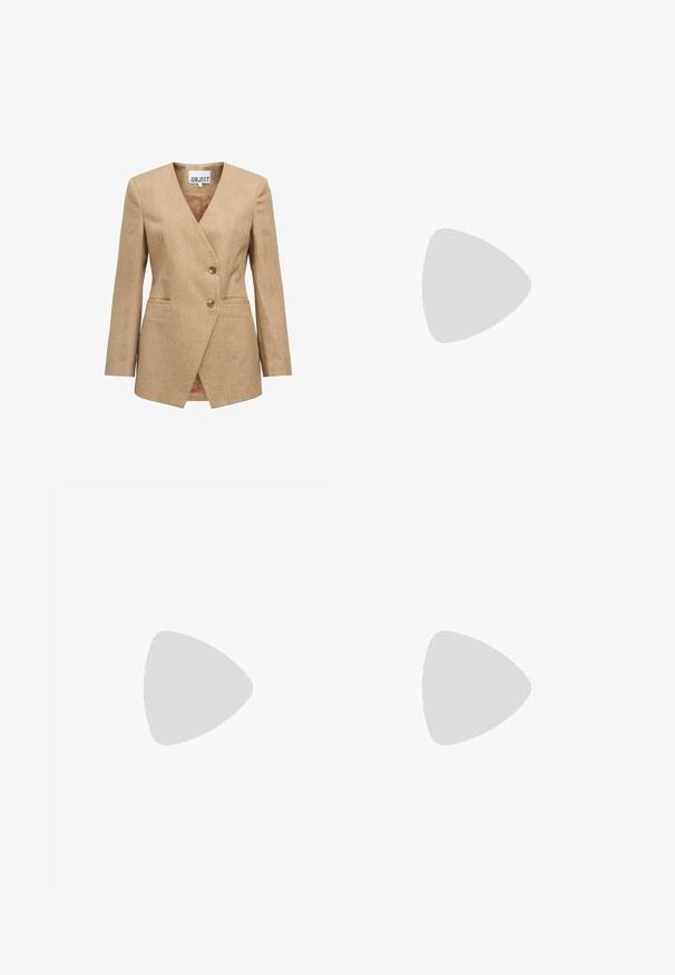 Beige blazer with a notched lapel, single-breasted design, two buttons, and side pockets. Textured fabric with a smooth inner lining.; White long-sleeve top with a deep V-neckline, ribbed texture on shoulders, and a fitted design. Label visible at the neckline.; White wide-leg jeans made of denim, featuring a high waist, four-pocket design, and raw hem at the bottom for texture.; Brown suede sneakers with white accents and laces. Rubber gum sole. Worn with white socks featuring black stripes. Green textured flooring.; Gold metal-framed sunglasses with green tinted lenses, oval shape, black temples, and clear nose pads. Clean, minimalist design.