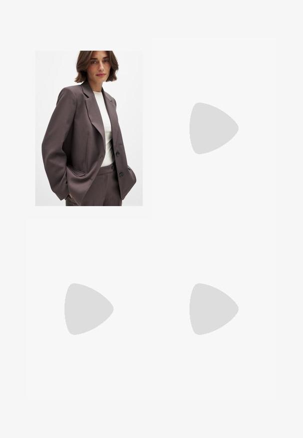 Dark brown blazer with a tailored design, featuring wide lapels, button closure, and side pockets. Paired with a light-colored top.; Brown short-sleeve t-shirt made of soft cotton fabric, featuring a round neckline and a simple, fitted silhouette.; Oversized brown blazer over a sheer black lace skirt with floral patterns, pairing with black heeled sandals.; Brown suede sneakers with white accents and laces. Rubber gum sole. Worn with white socks featuring black stripes. Green textured flooring.; Tortoiseshell sunglasses with rounded frames, dark lenses, and gold logo detailing on the temples. Smooth plastic material, no visible patterns.