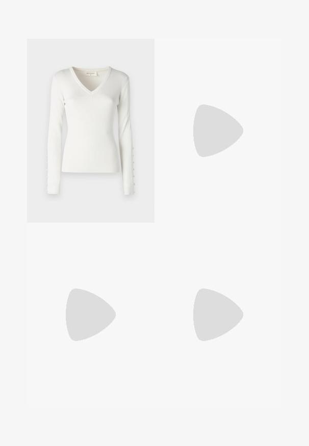 White ribbed long-sleeve top with a V-neck design and button accents along the sleeves. Soft texture with a fitted shape.; High-waisted skinny jeans in dark gray denim, smooth texture, featuring front pockets and a metal button closure at the waistband.; White leather sneaker with perforated toe box, textured sole, and white laces, paired with wide red pants and a blue and yellow background.; Silver hoop earrings with a minimalist design. Circular shape, smooth texture, and thin profile. Lightweight with a polished finish.