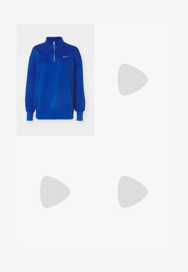 Sudadera azul de Nike con cuello alto, con media cremallera en la parte delantera, mangas largas y puños acanalados. Lleva un pequeño logo plateado en el pecho.; Camisa blanca de manga larga con cuello, que presenta bordados de ojales en un patrón de paisley y botones en la parte delantera.; Jeans de mezclilla de color azul oscuro con pierna acampanada y cintura alta, que cuentan con cinco bolsillos, cierre de botón y detalle de costura visible a lo largo de las costuras.; Zapatilla de cuero blanco con caja de dedos perforada, suela texturizada y cordones blancos, combinada con pantalones rojos amplios y un fondo azul y amarillo.