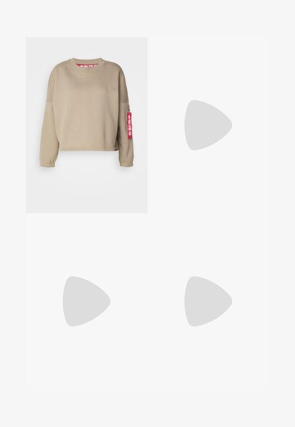 Beige cropped sweatshirt with long sleeves and elastic cuffs. Features a small logo patch and a red tag reading "REMOVE BEFORE FLIGHT."; Beige trousers made of cotton, featuring a relaxed fit, front pleats, a single button closure, and straight legs with stitched hems.; Nike athletic shoes with a silver mesh upper, white accents, and textured soles, paired with loose-fitting navy pants.; Silver hoop earrings featuring a smooth, glossy finish with a minimalist design and secure closure at the top.
