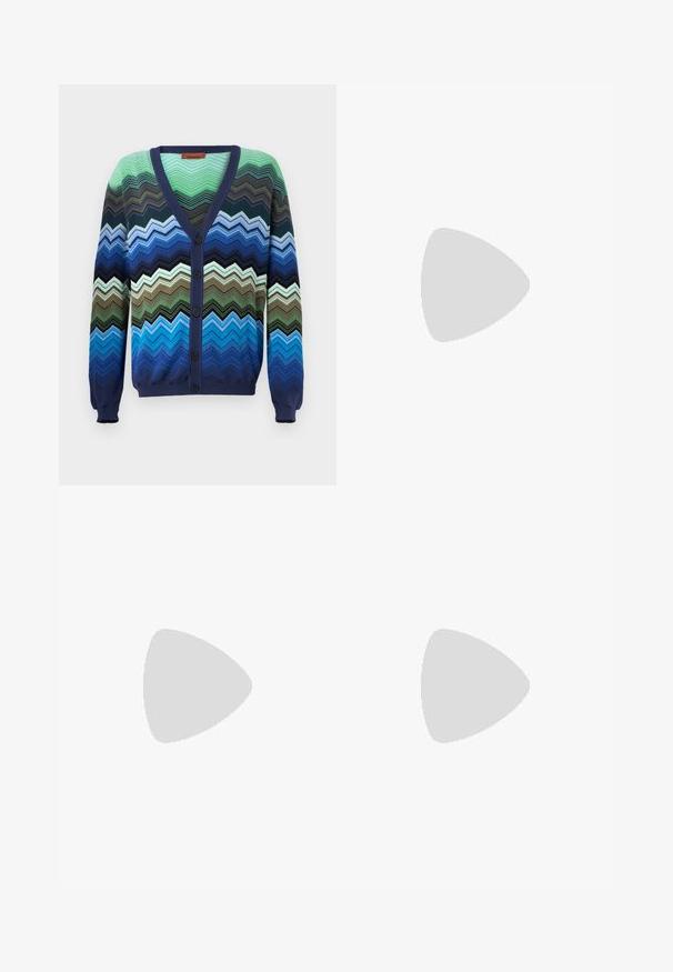 Multicolored zigzag patterned cardigan. Made of knit fabric, features a navy blue V-neck, button closure, and ribbed cuffs.; Light blue denim jeans with a straight cut, five pockets, a zipper fly, and contrasting stitching. Fabric has a smooth, textured finish.; White sneakers with a textured leather finish, rounded toe, and black heel accent. Rubber sole with small tread pattern and stitched detail.; Black leather backpack with textured surface, flap closure, metal hardware, side zip pockets, and brand logo on the front.