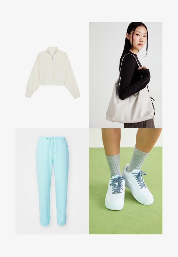 Zkrátený pulover z krémového materiálu, s vysokým golierom, polovičným zipsom, elastickým lemom a manžetami, s hladkou textúrou a minimalistickým dizajnom.; Svetlomodré teplákové nohavice s elastickým pásom, nastaviteľným šnúrkovým pásom a zúženými nohavicami. Vyrobené z mäkkej, hladkej látky bez viditeľných log. ; Biele kožené tenisky s modrými akcentmi, perforovaným dizajnom na špičke a textúrovanými modro-bielymi šnúrkami, nosené so sivými rebrovanými ponožkami.; Béžová kabelka vyrobená z mäkkého materiálu, s uvoľneným dizajnom, prišitými detailmi a dvoma popruhmi na nosenie na pleciach. Vhodná na každodenné nosenie.