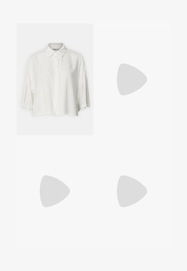 White short-sleeve blouse with a collared neck, button front closure, and a relaxed fit, made from a lightweight, smooth fabric.; Light blue flared jeans made of denim, featuring a high waist, five pockets, and a single button closure. Soft texture with faded finish.; Beige suede ankle boots with a pointed toe, curved top line, and a low stacked heel. Features stitching and a decorative overlay detail.; Black tote bag made of smooth leather, featuring a curved, open top with two shoulder straps and a minimalist design.