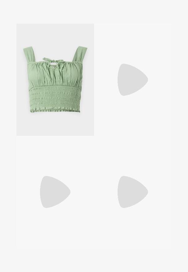 Haut court vert clair avec une texture froncée, bretelles larges et un col noué. Présente un tissu froncé pour un ajustement décontracté.; Pantalons en denim beige à jambes larges avec taille haute, dotés d'une fermeture à boutons et zippée à l'avant, de passants de ceinture et de poches latérales. Texture douce.; Baskets blanches avec des rayures noires et des accents en daim beige. Elles présentent une semelle en gomme texturée et des lacets plats blancs, portées avec des chaussettes claires.; Lunettes rectangulaires à verres transparents avec une fine monture en métal argenté et des embouts en acétate noir. Présente un matériel minimal pour un design épuré.
