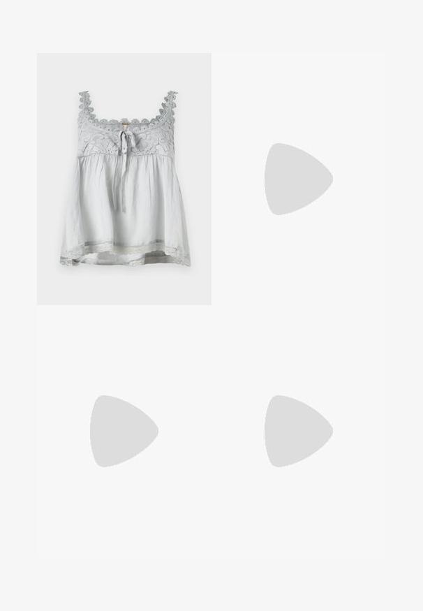 Top in tessuto grigio con bordo in pizzo e dettagli decorativi. Presenta un nodo frontale e una forma morbida e fluida. Spalline sottili.; Pantaloni a gamba larga in tessuto grigio scuro, con vita alta, pieghe singole e una texture liscia con una finitura pulita sui orli.; Scarpa Mary Jane in vernice nera con punta affusolata, cinturino regolabile e tacco a blocco, caratterizzata da una finitura lucida e un design minimalista.; Top crop a coste grigio e gonna a vita alta verde oliva. Il modello tiene una borsa a spalla bianca con dettagli intagliati. Design semplice, silhouette aderente.