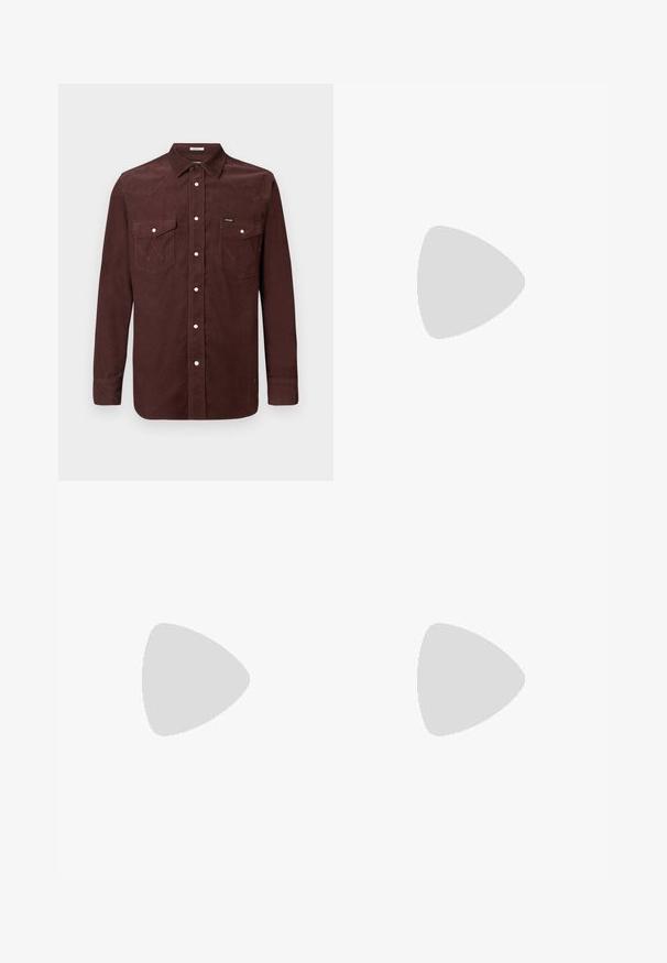 Camisa de pana marrón de manga larga con botones a presión, dos bolsillos en el pecho con solapas, y pequeño logo de Wrangler en el bolsillo izquierdo.; Camiseta negra de manga corta con cuello redondo y un pequeño parche cuadrado del logo de Carhartt en el bolsillo del pecho izquierdo.; Pantalones marrones de pierna ancha fabricados en algodón, con cierre frontal de botón, lazos para cinturón y una textura suave y mate.; Zapatillas de ante marrón con cordones blancos y diseño de raya lateral, combinadas con pantalones marrones claros sobre un suelo verde.