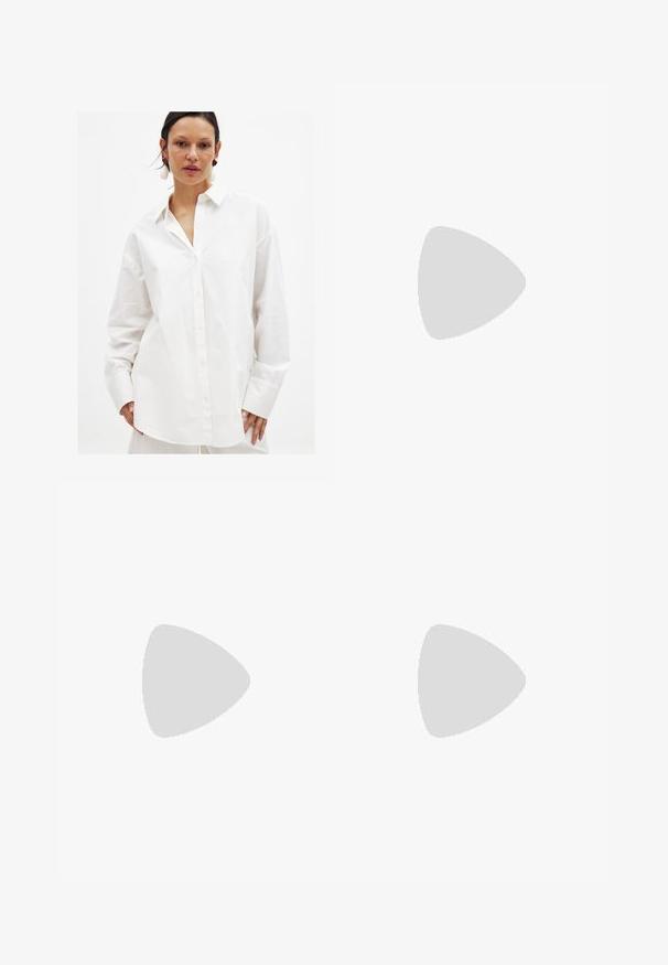 White button-up shirt made of smooth cotton. Features a classic collar, long sleeves, and a loose fit with subtle texture.; Light blue denim jeans with wide leg design, front button and zipper closure, two front pockets, and two back pockets, featuring cuffed hems.; Brown suede loafers with a slightly raised heel, a smooth texture, stitching details on the front, and a rounded toe design.; Brown leather handbag with a conical shape, sturdy handles, and contrasting white stitching. Features a detachable shoulder strap for versatility.