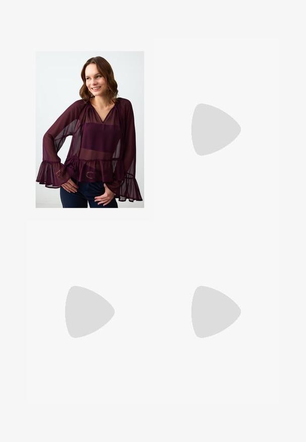 Camicia trasparente borgogna con scollo a V, maniche lunghe, polsini arricciati e orlo a peplum. Presenta accenti sottili sulle maniche.; Pantaloni larghi blu navy in tessuto morbido, con pieghe frontali, passanti per cintura e tasche laterali. Include una chiusura a bottone in vita.; Scarpe sportive con tomaia in pelle bianca, punta in suede grigia e tre strisce nere. Presentano un logo blu sulla linguetta e una suola in gomma testurizzata.; Borsa a tracolla in pelle bordeaux con forma curvata, una sola tracolla e dettagli cuciti al centro. Texture liscia, hardware minimale.