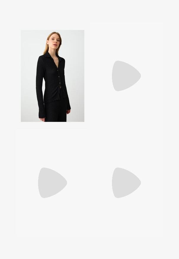 Camicia nera con bottoni, realizzata in tessuto testurizzato, maniche lunghe e colletto. Presenta piccoli bottoni dorati e un design aderente.; Pantaloni neri a gamba larga con pieghe, caratterizzati da una texture liscia e un design a vita alta. Stile minimalista, senza hardware o decorazioni visibili.; Décolleté in vernice nera con punta affusolata e tacco in geometria cubica. Presentano un design elegante e minimalista, con una texture liscia.; Borsa hobo nera in pelle con una superficie liscia, forma curvata e una singola tracolla regolabile; presenta un'ampia apertura nella parte superiore.