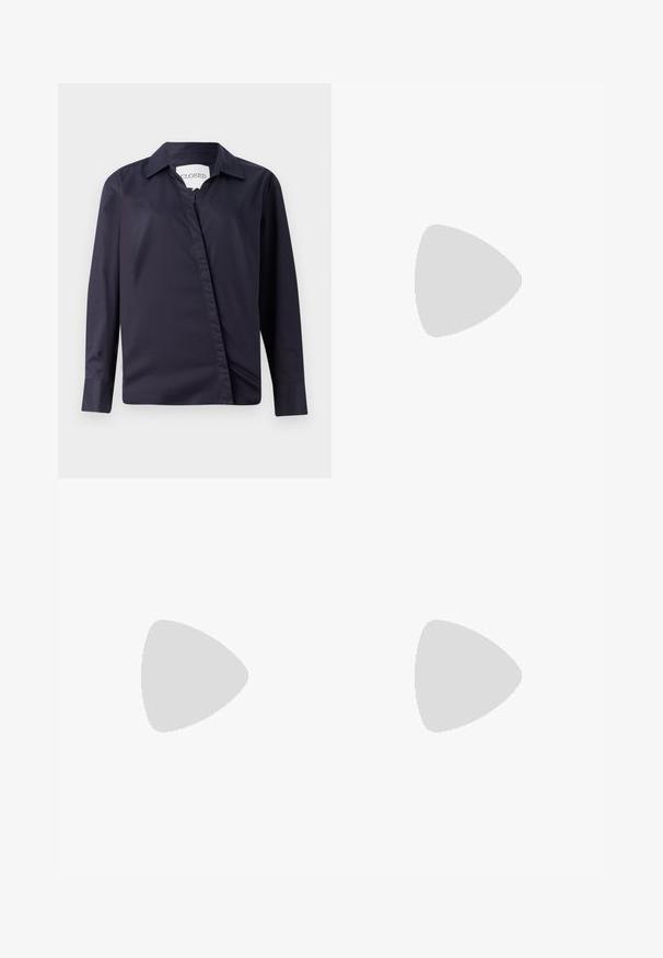 Mörk marinblå skjorta i slät tyg, med klassisk krage, långa ärmar och en asymmetrisk framknäppning.; Stickad vit midi-kjol med en strukturerad mönster med vertikala linjer och utskärningar vid fållen. Elastisk midja. Mjuk material.; Svart läderballerinaskor med rund tå, slät yta, minimala söm detaljer och en flexibel sula.; Brun läderhandväska med klaffstängning, guldfärgad hårdvara, axelrem och en slät yta. Kompakt rektangulär form.