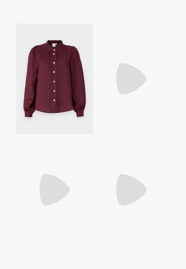 Burgundy long-sleeve button-up shirt with a collar, featuring pleats and decorative buttons. Made from textured fabric, with gathered sleeves.; Black wide-leg trousers with high waist, button details on waistband, and front pleats.; Black leather pump with a pointed toe and a low block heel. Features an ankle strap with a gold-tone buckle. Smooth texture.; Black handbag with structured shape, smooth texture, and a metallic clasp. Paired with wide black pants and open-toe sandals on wooden floor.