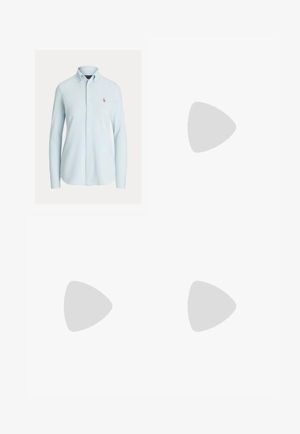 Light blue button-up shirt with a classic collar, long sleeves, and a small embroidered logo on the left chest. Cotton material, smooth texture.; Brown cotton trousers with a slim-fit design, flat front, and standard pockets; smooth texture and hemmed cuffs.; White leather sneakers, low-top design, featuring a smooth texture, round toe, laced front, and a small embroidered logo on the side.; Black leather half-moon bag with a gold hardware accent, featuring a zip closure. Worn crossbody over a gray sweater.