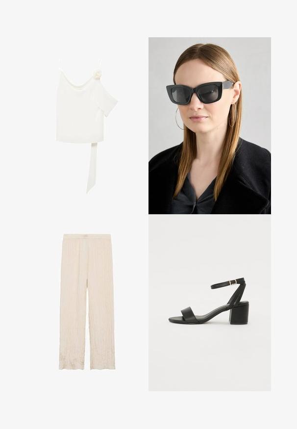 Bluză albă cu un design pe un umăr, având un accent floral pe o parte și un panou lung, legat în talie. Textură netedă.; Pantaloni plisati light beige cu talie elastică, având un design cu picioare largi și un finisaj dintr-un material moale, texturat.; Sandale cu toc înalt negre, cu un superior din piele netedă, vârf deschis, curele frontale late și curea pentru gleznă ajustabilă cu detaliu din aur.; Ochelari de soare negri tip cat-eye cu lentile întunecate, rame groase și accente subtile. Purtați cu o haină neagră și un top gri, având părul lung și drept.