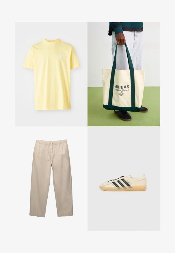 Žluté bavlněné tričko s kulatým výstřihem a krátkými rukávy. Obsahuje malý bílý grafický design na levé hrudi.; Béžové, lehké bavlněné kalhoty s elastickým pasem a šňůrkou. Široký střih a ohrnuté lemy. Hladká textura, minimální detaily.; Světle krémové tenisky s černým designem tří pruhů,Texturovaný svršek, kulatá špička a gumová podešev. Obsahují šněrování a branding po straně.; Osoba držící béžovou tašku Adidas s tmavě zelenými rukojetmi, oblečená v světle šedých kalhotách a černých teniskách na zelené podlaze.