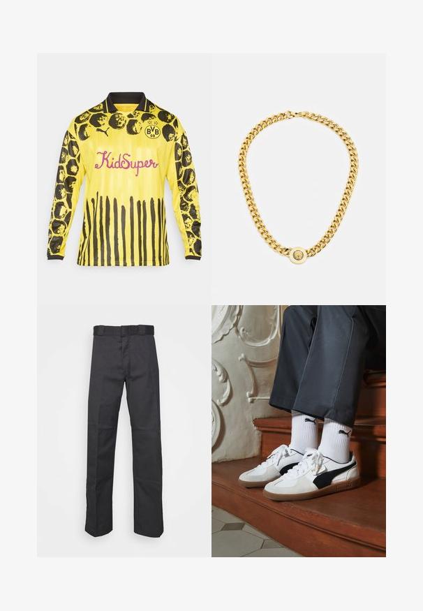 Yellow long-sleeve football jersey featuring black circular and stripe patterns, black collar, and "KidSuper" in pink lettering.; Black pants made of durable fabric, featuring a straight leg design, a waistband with belt loops, and seams for added texture.; Puma sneakers in white and black suede, featuring a brown rubber sole. Paired with white socks displaying a black logo, worn with dark pants.; Gold chain necklace with large interlocking links, featuring a circular pendant detail at the center with a raised emblem.