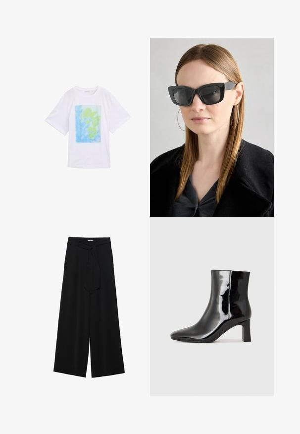 Witte katoenen t-shirt met een rechthoekige grafische print in blauwe en groene abstracte patronen aan de voorkant. Korte mouwen en ronde hals.; Zwarte wijde broek van textuurstof, met een elastische tailleband en een afneembare sjaalstrik in de taille voor een verstelbare pasvorm.; Zwarte gepolijste leren enkellaars met een spitse neus en een blokhak van gemiddelde hoogte. Glad textuur en minimalistisch ontwerp.; Zwarte cat-eye zonnebril met donkere lenzen, dikke monturen en subtiele accenten. Draagt een zwarte jas en een grijze top, met lang stijl haar.